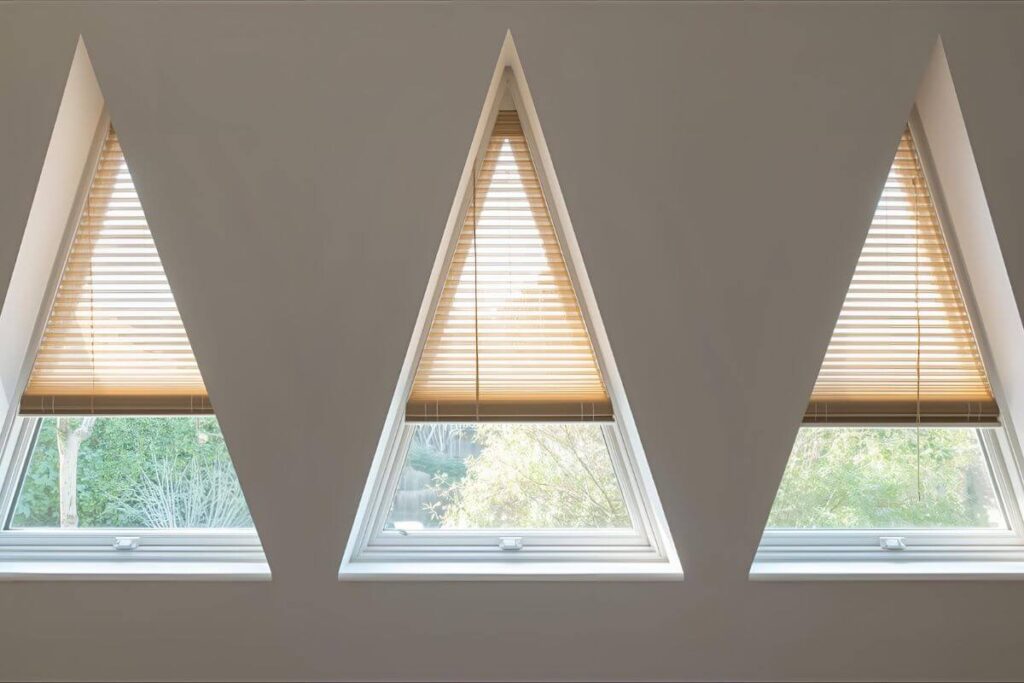 Triangular windows with roller, cellular, and wood blinds
